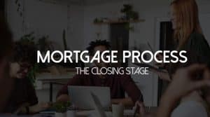 Mortgage process overview image highlighting the closing stage, featuring a group of diverse individuals engaged in discussion around a laptop in a modern setting.